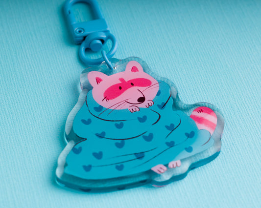 Raccoon in a Blanket - Acrylic Keychain